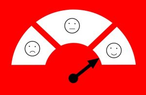 A customer satisfaction meter with the arrow pointing at a smiley face.