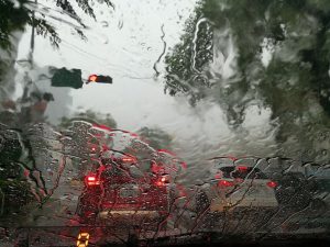 Image is heavy summer rains as seen through the windshield of a car. Image is heavy summer rains as seen through the windshield of a car.