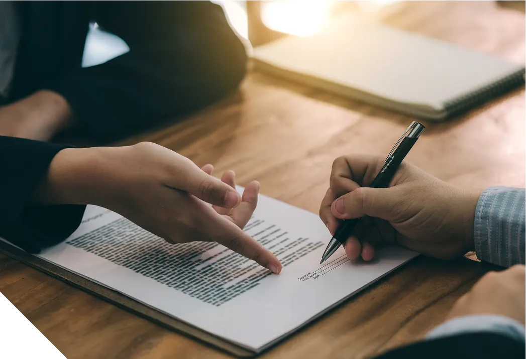 Photo of a person signing a contract.